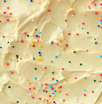 Close up image of cake frosting texture background with sprinkles on top