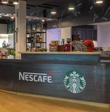 Streetwise IR business news on Nestlé (image of Nescafé coffee bar at Nestlé R&D center).