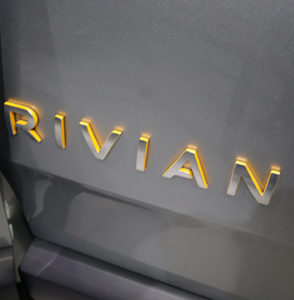 Image of Rivian logo plate.