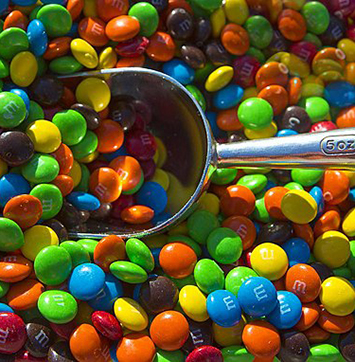 Image of M&M candies with scoop.