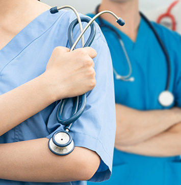 Closeup image of nurse holding stethoscope.