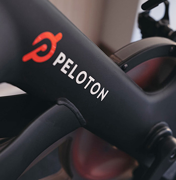 Closeup image of Peloton logo on bike machine