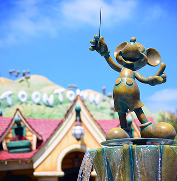 Image of Disneyland Toontown, with statue of Mickey Mouse in foreground.