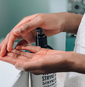 Image of hand washing with Stryke Club skin care.