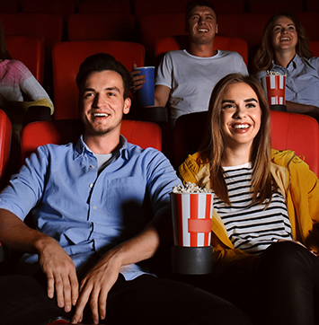 Image of Young people watching movie in theater.