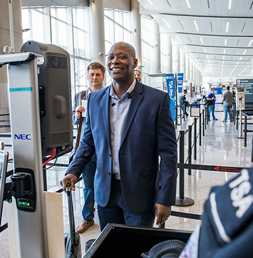 Image of customer using facial recognition as identification at TSA security checkpoint.