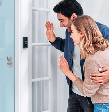 Image of couple waving into Ring Video Doorbell.