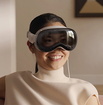 Image of woman wearing Apple Vision Pro headset.