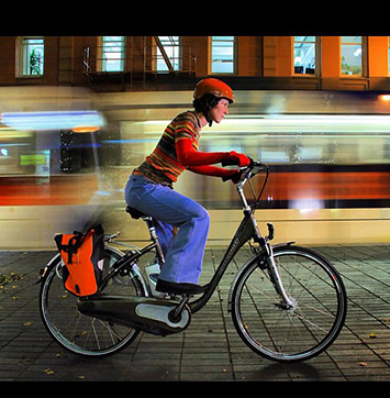 Image of woman riding ebike at night.