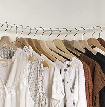 Image of clothes hanging on a rack.