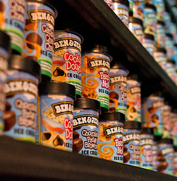Image of cartons of Ben & Jerry's ice cream on shelves.