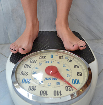 Image of person standing on weight scale.