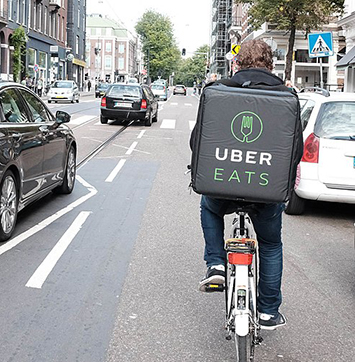 Image of Uber Eats bicyclist in traffic.