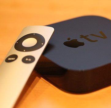 Image of Apple TV+ remote and console.